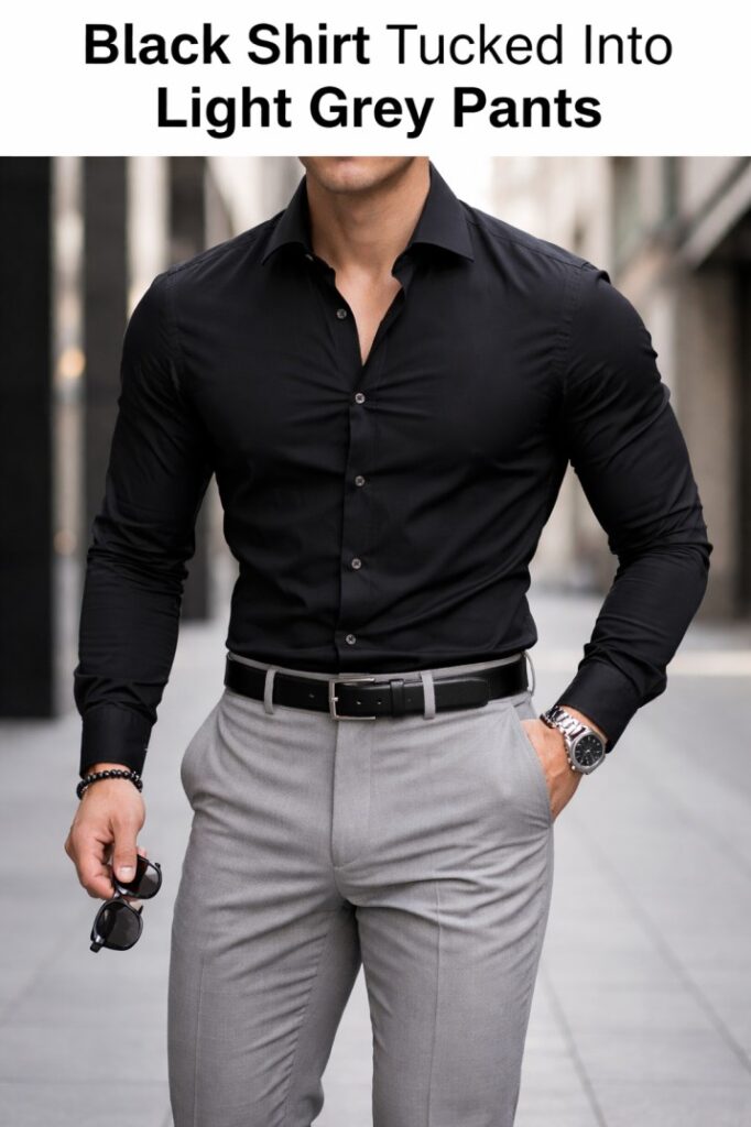 Black shirt tucked into light grey pants